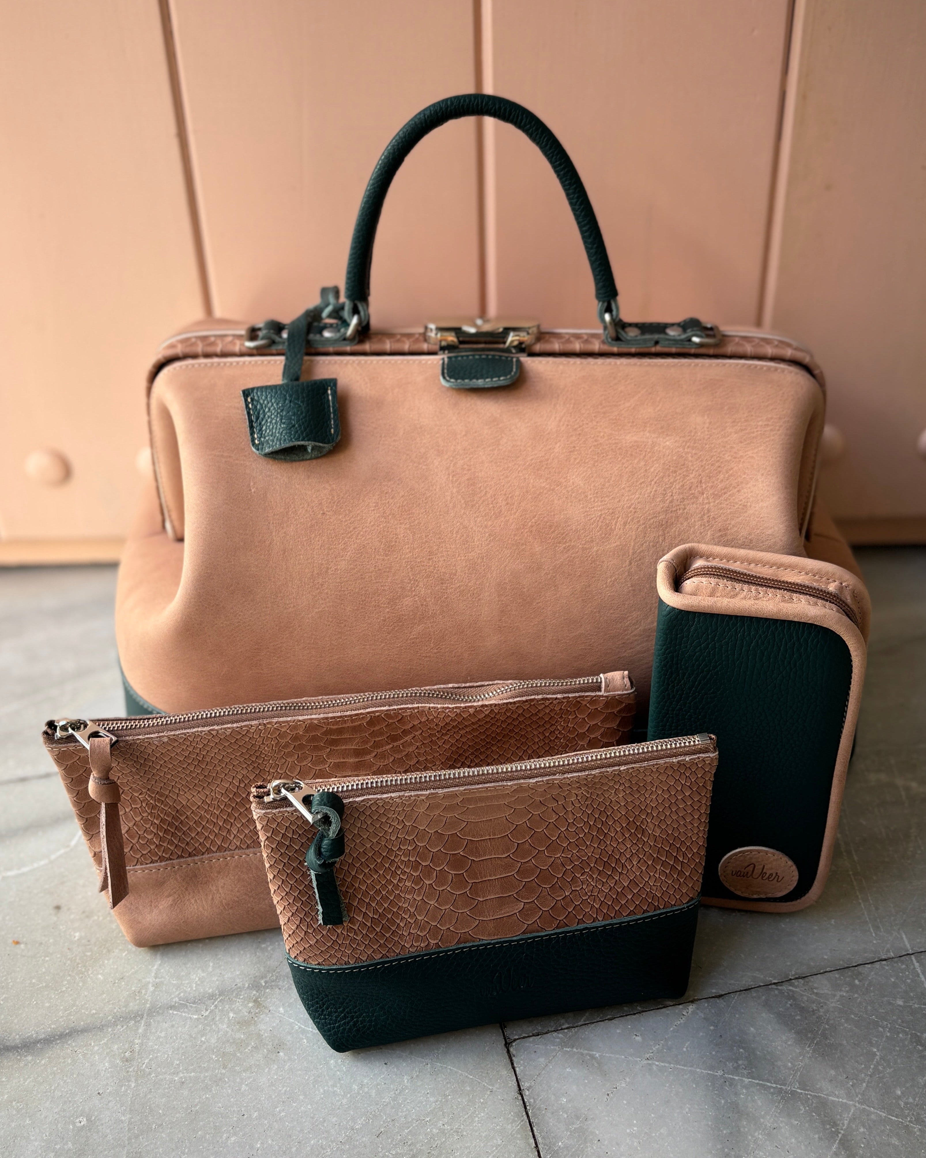 Set of brown handbags with black accents on a light gray floor.